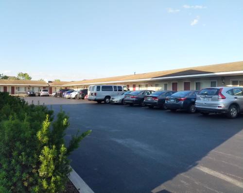 un groupe de voitures garées devant un bâtiment dans l'établissement Driftwood Motel, à Niagara Falls