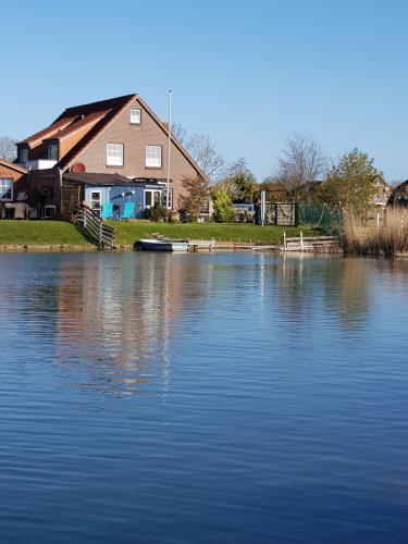 una casa junto a un gran cuerpo de agua en Ferienhaus Poseidon, en Neuharlingersiel