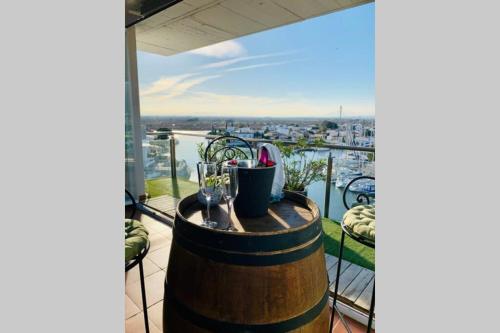 a barrel on a balcony with a view of a harbor at Les Marines in Roses