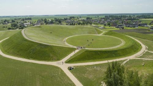 an aerial view of a park with people in the grass at Baltas gandras in Naisiai