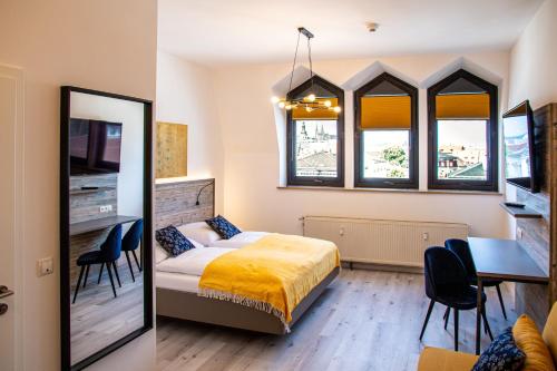 a bedroom with a bed and a table and chairs at City Hotel Bamberg in Bamberg