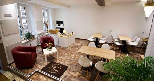 an office with tables and chairs in a room at Hôtel Le Chambellan in Dijon