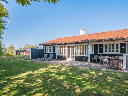 a house with a patio and a yard at Holiday Home Sandskærvej II in Aabenraa