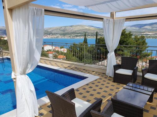 トロギールにあるLuxury Villa Star Lights Trogir - heated pool, hot tub, gym, billiardのプール付きで、海の景色を望むヴィラです。