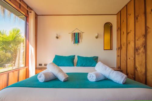 Cama ou camas em um quarto em Pao Pao Lodge Algarrobo