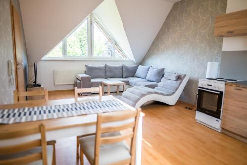 a living room with a couch and a table at Apartmá Kateřina Velké Losiny in Velké Losiny