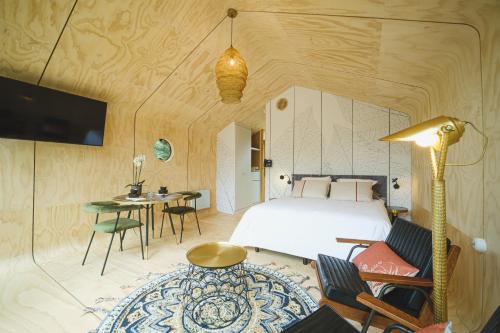 a bedroom with a bed and a table and chairs at Domaine de la Résidence - Hôtel, Spa & Restaurant in Moulins-lès-Metz