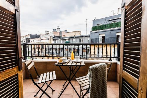 a balcony with a table and chairs on a balcony at ZABALETA SUITE by Sweet Home SS Rentals in Donostia-San Sebastián