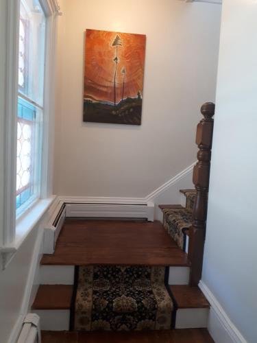 a stairway with a painting on the wall at Hillside Landing B&B in Digby