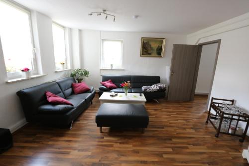 a living room with two couches and a table at Ferienwohnung Both in Wernigerode