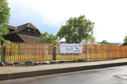 a sign on a fence in front of a house at Ferienwohnung Both in Wernigerode