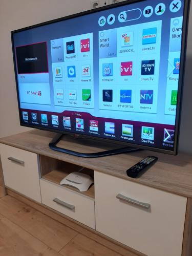 A television and/or entertainment centre at Lux Apartment in the City Center