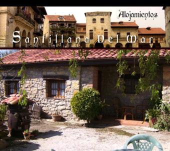 a picture of a building with a sign on top of it at Apartamentos Fernando in Santillana del Mar