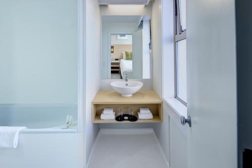 a bathroom with a sink and a mirror at Willis Wellington Hotel in Wellington