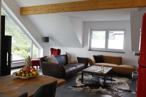 a living room with a couch and a table at Rooftop Moselsuite in Cochem