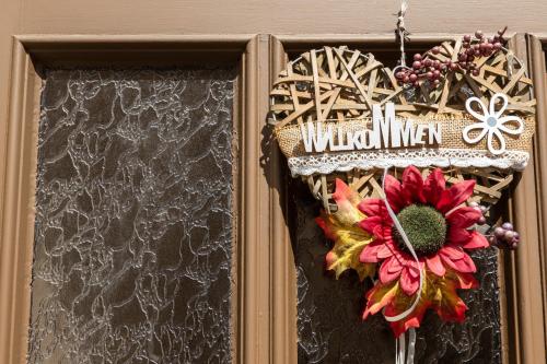 a christmas wreath with a flower on a door at An der Abzucht in Goslar