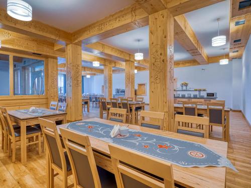 a dining room with wooden tables and chairs at Strama Kościelisko in Kościelisko