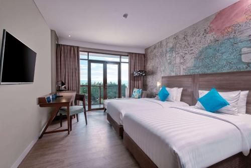 Wyndham Garden Kuta Beach Bali में एक कमरे में एक या कई बेड