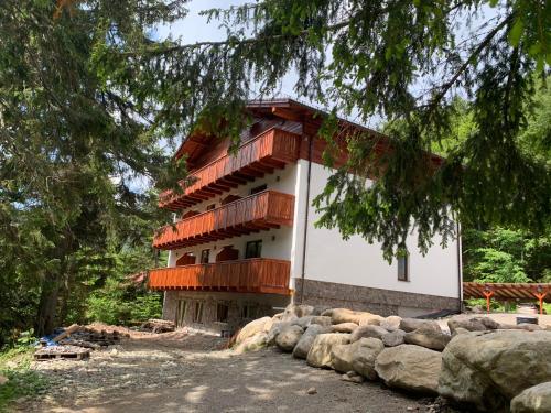 a building with wooden balconies on the side of it at Apartmán Jeleň Chopok Juh-Trangoška in Tale