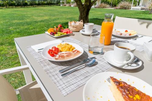 un tavolo con prodotti per la colazione e succo d'arancia di Quinta Dos Perfumes a Tavira