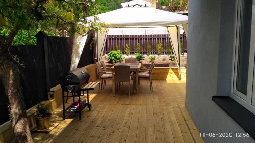 a patio with a table and a white umbrella at Apartament KAOLA in Jelenia Góra