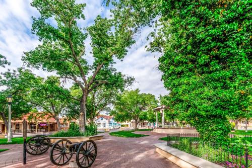 a bike parked next to a park with trees at Super 8 by Wyndham Albuquerque West/Coors Blvd in Albuquerque