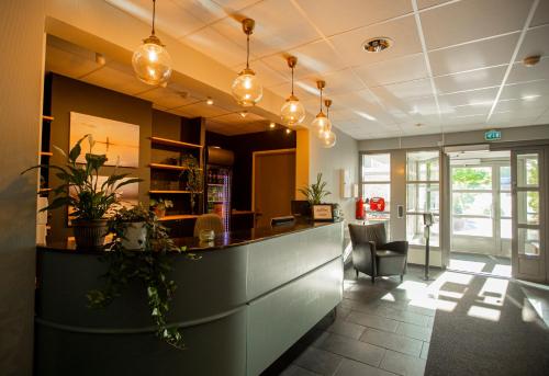 a lobby with a bar in a restaurant at Strandnäs Hotell in Mariehamn