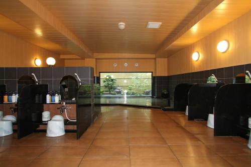 a large bathroom with a sink and a mirror at Hotel Route Inn Kesennuma Chuo Inter in Kesennuma