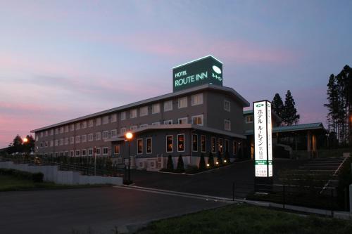 a large building with a sign in front of it at Hotel Route Inn Kesennuma Chuo Inter in Kesennuma