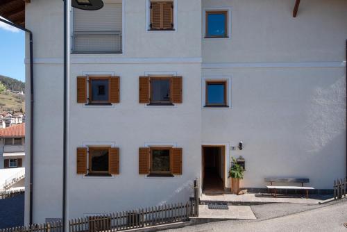 um edifício branco com janelas castanhas com persianas em Apartment 7 - Zur Sonne em Laion