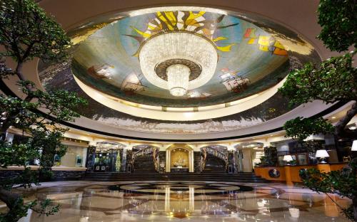 a large lobby with a large painting on the ceiling at Hotel Lisboa in Macau