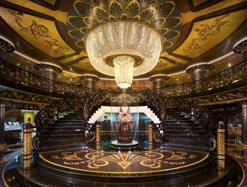 a large building with a chandelier and stairs on a cruise ship at Hotel Lisboa in Macau