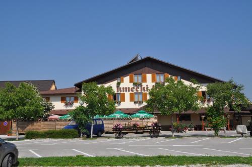 a hotel with a parking lot in front of it at Penzion Kmečki Hram in Ljubljana