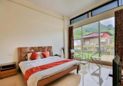 a bedroom with a bed and a large window at Rainforest Resort and Spa, Igatpuri -Nature's Luxury Awaits in Igatpuri