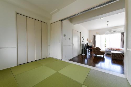 a living room with a green and white floor at Odysis Onna Resort Hotel in Onna