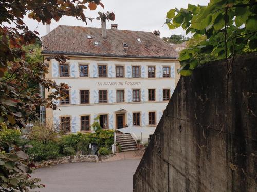 a large white building with a sign on it at Hôtel La Maison du Prussien in Neuchâtel