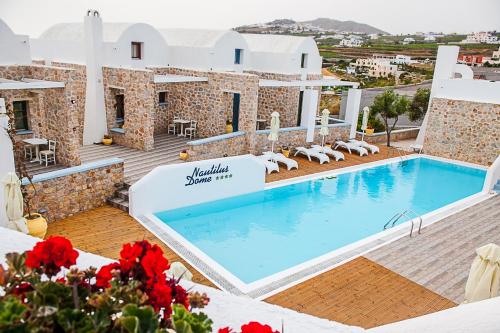 a view of a swimming pool on a resort at Nautilus Dome in Fira