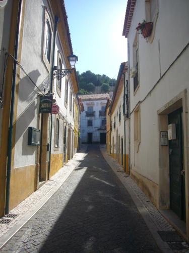 an empty alley with buildings on either side at Castle, Terrace and Relax in Tomar