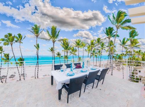 a table on the beach with a view of the ocean at Dream Punta Cana Beachfront Apartment - 4-Bedroom Penthouse with Rooftop BBQ & Ocean Views in Punta Cana