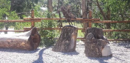 a playground with three logs and a wooden fence at Browns Canyon Inn in Salida