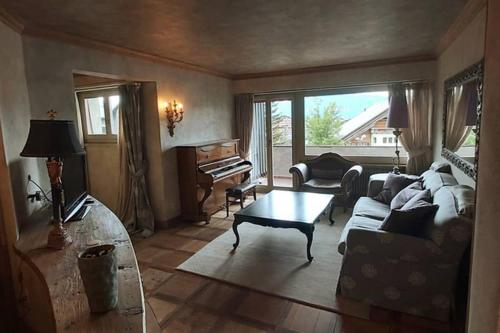 a living room with a couch and a table at Beautiful apartment over the mountain in Crans-Montana