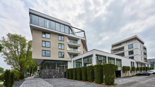 a tall building with a lot of windows at EINSTEIN Hotel am Römerpark in Andernach