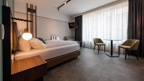 Krevet ili kreveti u jedinici u objektu Metropol Apartments & Suites