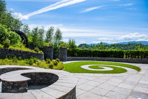 a garden with a spiral in the grass at Killarney Heights Hotel in Killarney