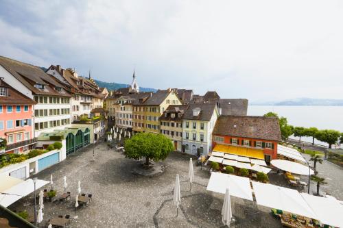 a view of a city with buildings and a lake at Hotel Löwen am See in Zug