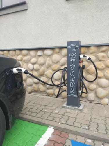 a car is being plugged into a charging pole at Hotel POD HERBEM -POKOJE OZONOWANE in Białystok