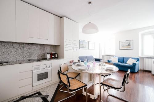 a kitchen and living room with a table and chairs at Downtown Como-Porta Torre Flat in Como