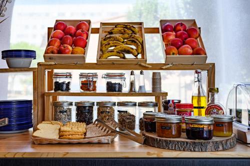 a counter with jars of food and baskets of apples at Hotel Gascogne in Toulouse