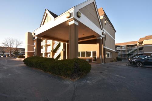 a parking lot in front of a building at HomeTowne Studios by Red Roof Denver - Lakewood West in Lakewood