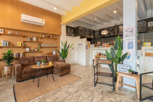 a store with a couch and a table in a room at BEDGASM Hotel x Cafe Nimman in Chiang Mai